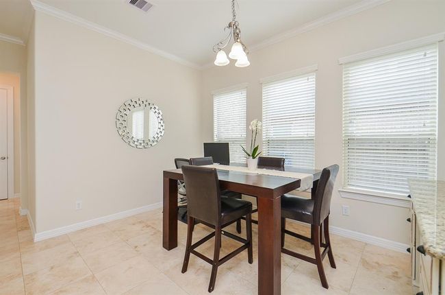 Bright and open breakfast room with built in-desk. | Image 16