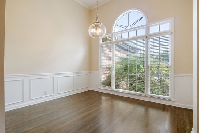 Light filled formal dining room with hardwoods and updated lighting. Plenty of space for large table, sideboard, and China cabinet | Image 5
