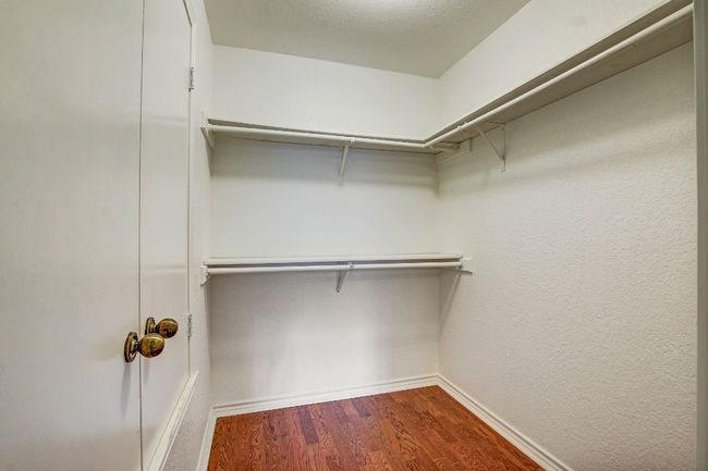 Walk in closet with wood flooring | Image 21
