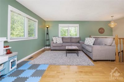 Inviting main floor ft open conceptlayout, gleaming hardwood floors & an abundance of natural light in living & dining areas. | Image 3