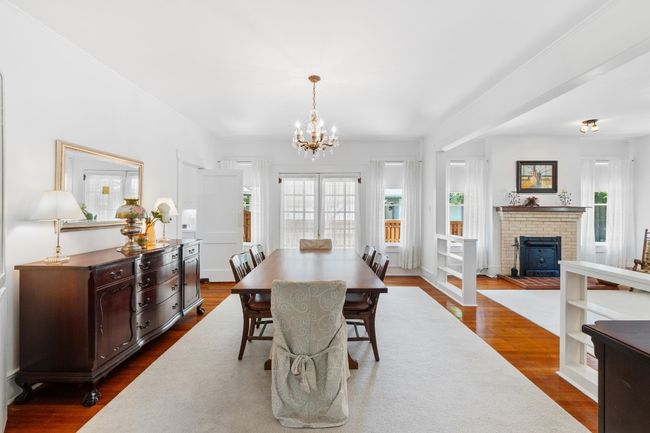 Dining area with plenty of natural light, a chandelier, and wood floors | Image 9