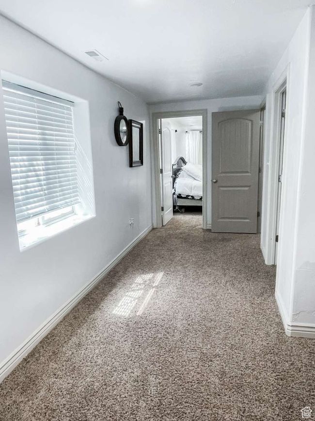 Corridor featuring carpet and baseboards | Image 19