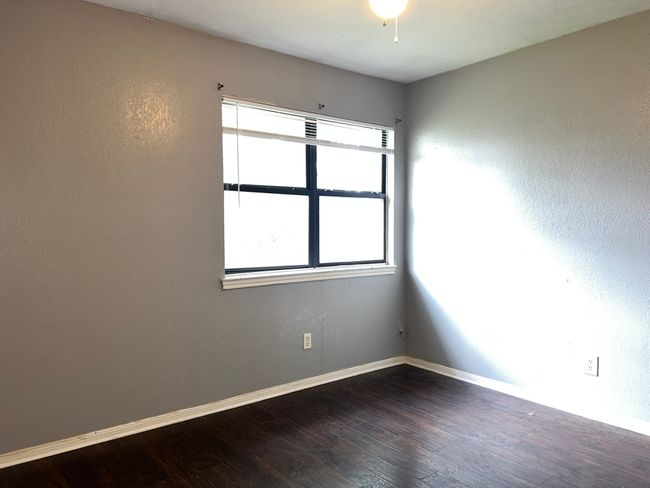 Unfurnished room with dark wood finished floors and baseboards | Image 18