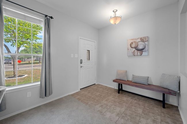 Foyer featuring baseboards and light tile patterned floors | Image 6