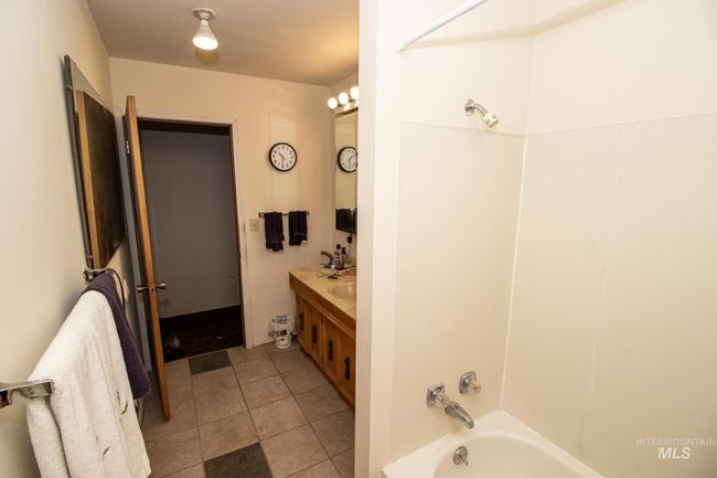 Full bathroom with vanity, shower / tub combination, and tile patterned floors | Image 25