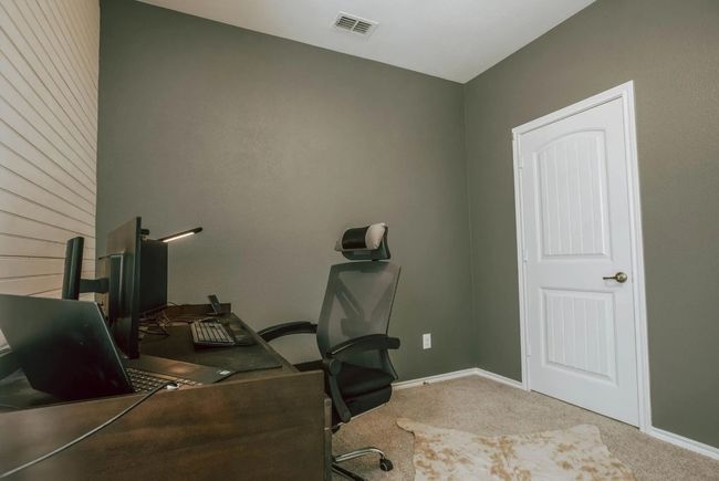 Carpeted home office featuring visible vents and baseboards | Image 12