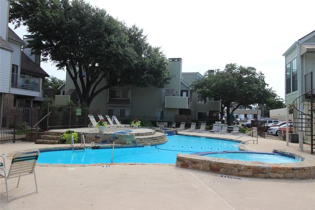 View of swimming pool featuring a residential view, a pool with connected hot tub, fence, and a patio | Image 18