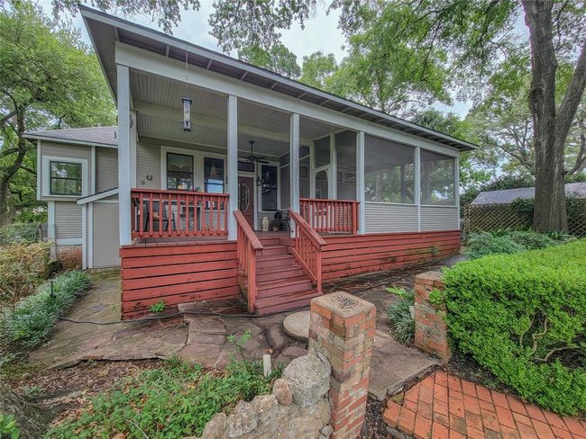 Enjoy stunning views from the covered and screened porches, extending into a private backyard oasis. | Image 32