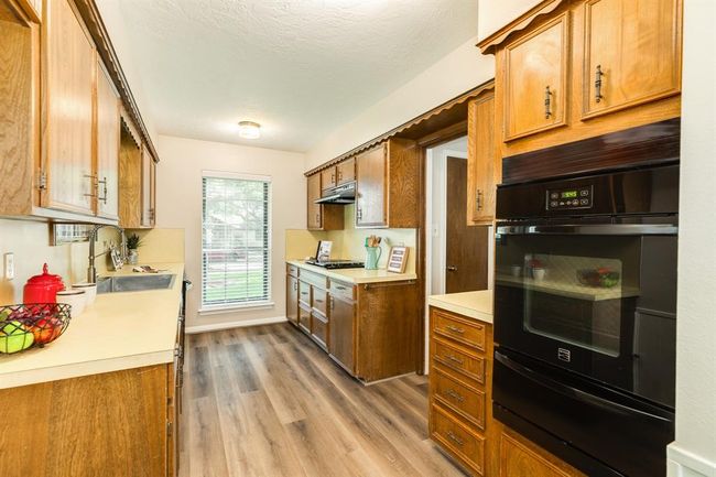 Spacious kitchen with gas range, gas oven w/ warmer, farm style stainless sink and an abundance of counter & cabinets. LVP throughout the living spaces. | Image 16