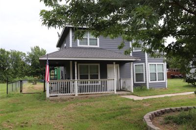 View of front of property featuring a porch and a front yard | Image 2