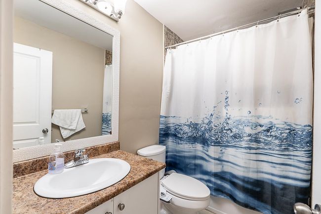 Bathroom with vanity and a shower with shower curtain | Image 28