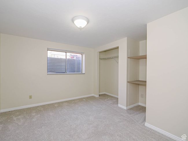 Unfurnished bedroom with light colored carpet and a closet | Image 49