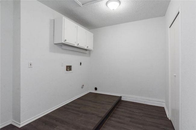 Laundry and utility room with painted cabinets. Closet to the right for storage. Washer and dryer hook-ups. | Image 17