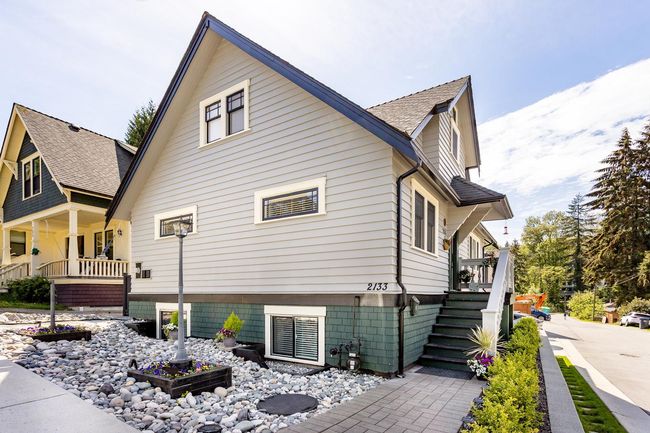 View of side of property featuring stairs, a porch, and a shingled roof | Image 35