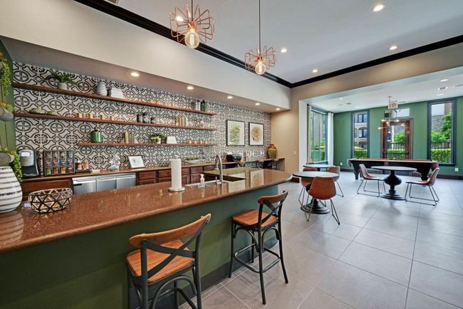 Bar featuring light tile patterned floors, a sink, wet bar, and crown molding | Image 10