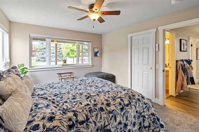 Carpeted bedroom featuring a ceiling fan | Image 32