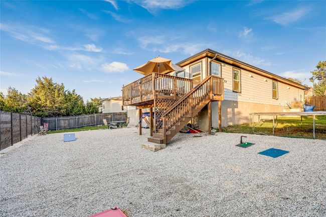 Rear view of house with a wooden deck and stairs | Image 15