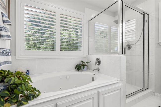 Bathroom with a shower stall, healthy amount of natural light, and a jetted tub | Image 29