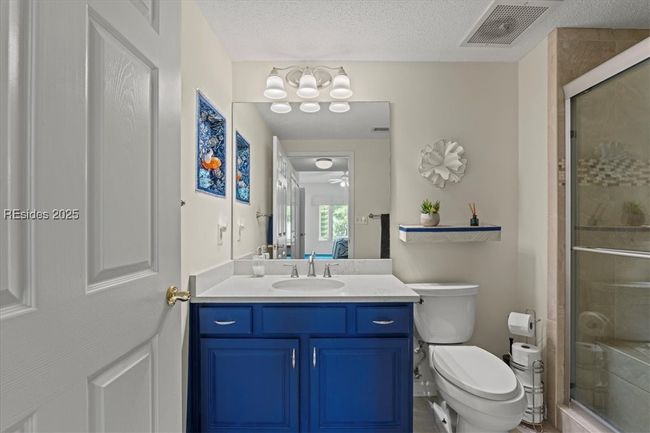 With the tiled shower and fun vanity color - it's private and spacious, too. | Image 20