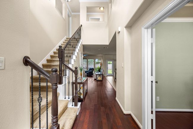 Large hall entry, grand height up to the second floor, and beautifully polished manufactured wood floors welcome you in this entry way. | Image 5