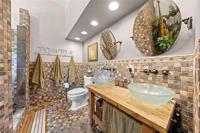Main Home - Here is your Spa Retreat in the Primary Bathroom with double vanities and a walk in shower. | Image 49