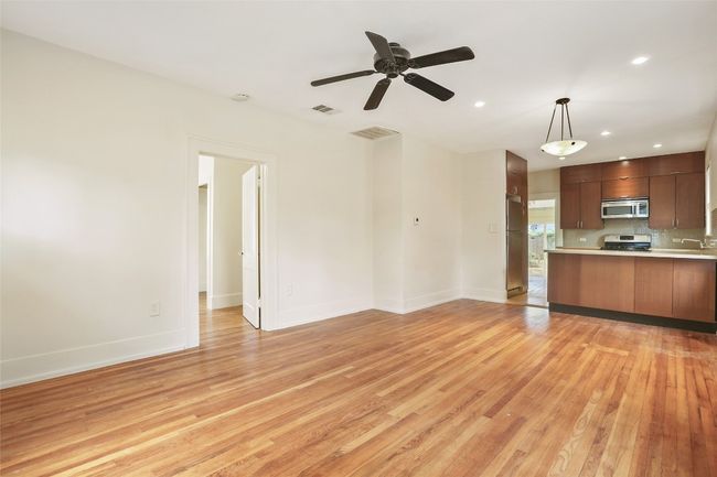 Unfurnished living room with light wood-type flooring, a ceiling fan, and recessed lighting | Image 8