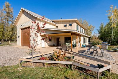 Rear view of property featuring a patio and a garage | Image 3