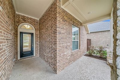 The covered front porch offers a warm and inviting welcoming while adding to the home’s curb appeal. | Image 2