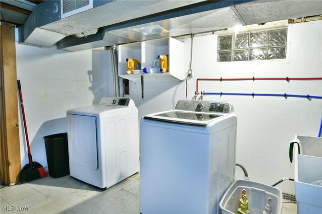 Laundry area with washing machine and clothes dryer and laundry area | Image 46