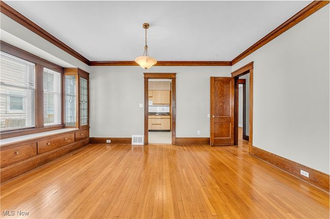 Unfurnished room with ornamental molding, visible vents, light wood-style flooring, and baseboards | Image 8