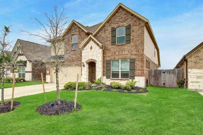 This home has pretty landscaping and a nice size yard | Image 1