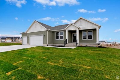 View of front facade featuring a front yard and a 3 car garage | Image 2