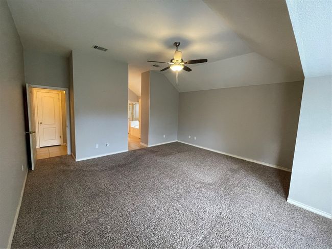 Additional living space with a ceiling fan, lofted ceiling, and carpet floors | Image 23
