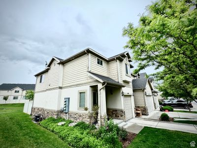 View of side of home featuring a garage and a yard | Image 2