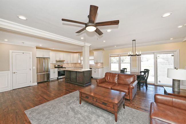Living area featuring ornamental molding, ceiling fan, dark wood-style flooring, and recessed lighting | Image 26