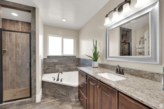 Full bath with vanity, a bath, and a stall shower | Image 10