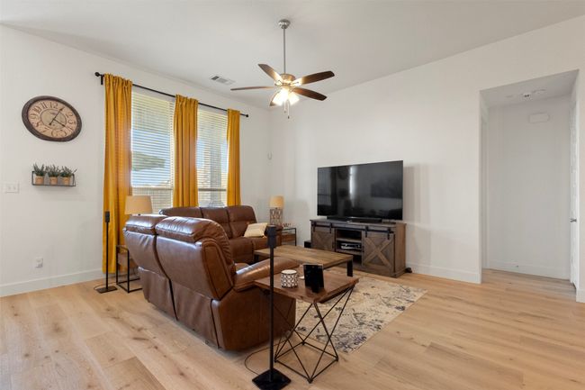 Living area with light wood-type flooring and ceiling fan | Image 22