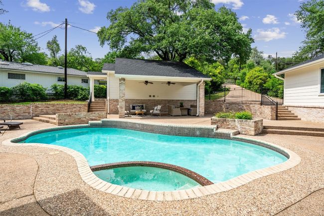 View of pool with an outdoor living area equipped with two ceiling fans | Image 25
