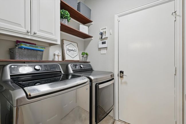 Laundry area with washing machine and dryer and cabinet space | Image 29
