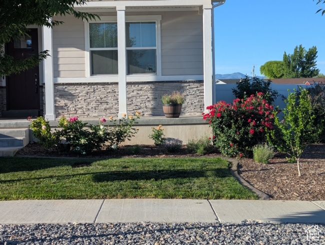 View of home's exterior with stone siding and a yard | Image 27