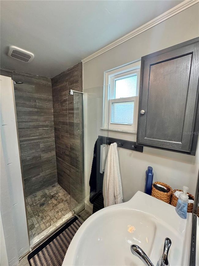 Primary full bathroom with stand up shower and barn door to cover laundry closet with stackable washer/dryer | Image 19