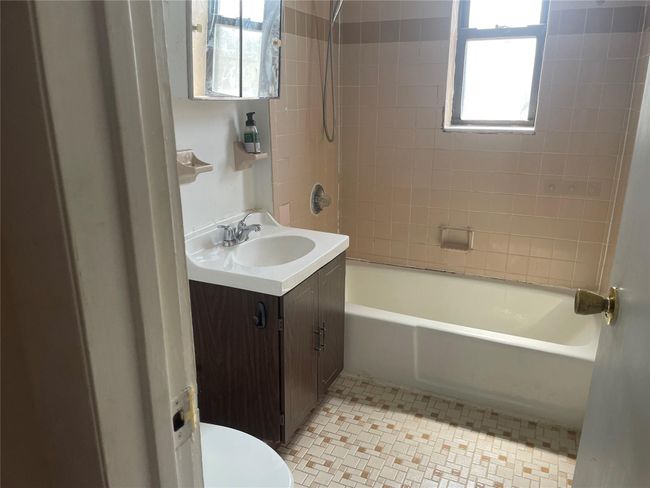 Bathroom with vanity, toilet, shower / bath combination, and tile patterned flooring | Image 11
