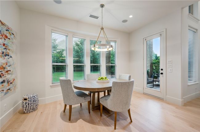 Dining area featuring light wood-type flooring, baseboards, and recessed lighting | Image 11