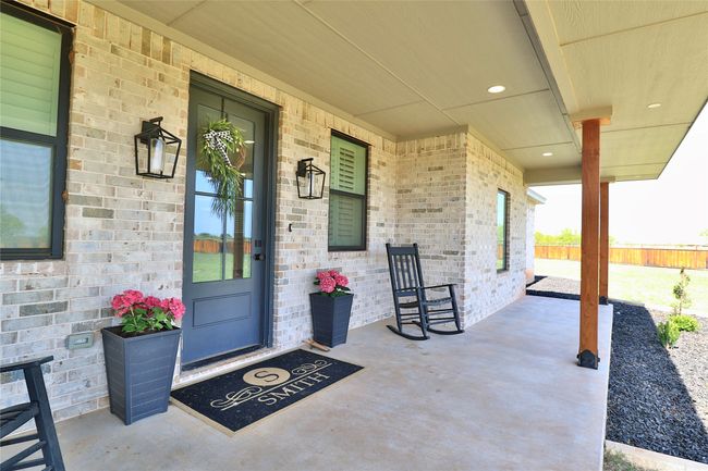 View of exterior entry with brick siding and a porch | Image 5
