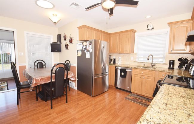 Eat-in Kitchen featuring light brown cabinets, a sink, stainless steel appliances, and visible vents | Image 8