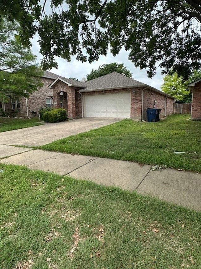 View of front of house with a garage, driveway, and brick siding | Image 21