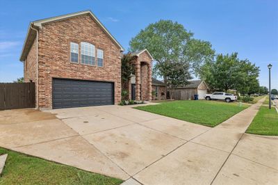 View of property featuring a front lawn and a garage | Image 2