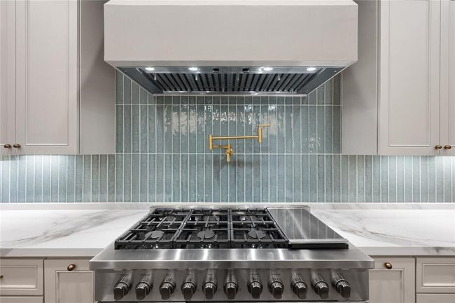 Featuring a convenient pot filler and a 48" gas range. | Image 20