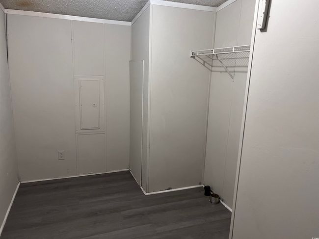 Spacious closet with wood finished floors and electric panel | Image 14