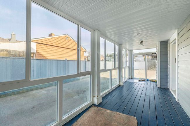 View of unfurnished sunroom | Image 7